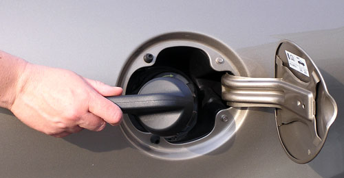 hand holding a Gas Cap Tool in what problems can a loose gas cap cause